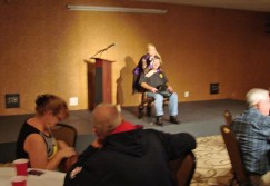 Jerry Duckworth being serenaded by C.J. Newsom our entertainer at the Meet and Greet. 